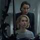 Kristin Scott Thomas (standing) and Lily James in Rebecca